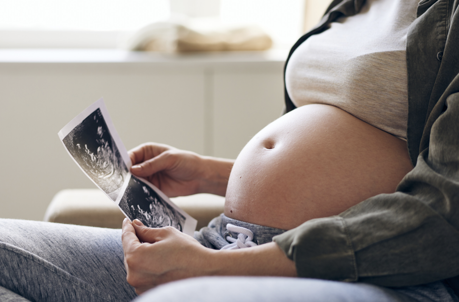 pregnant woman looking at ultrasound images
