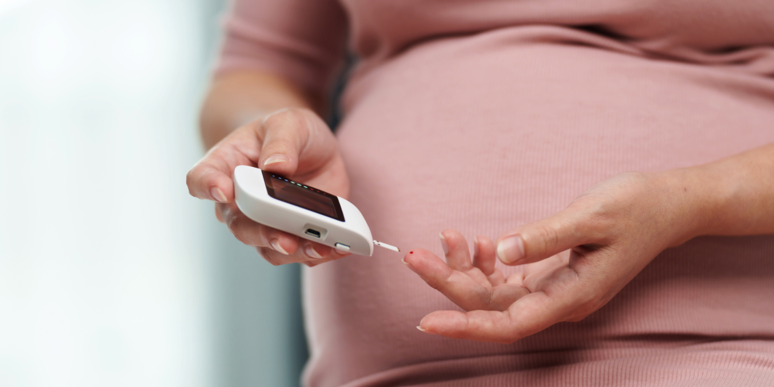 pregnant women testing blood sugar levels for gestational diabetes