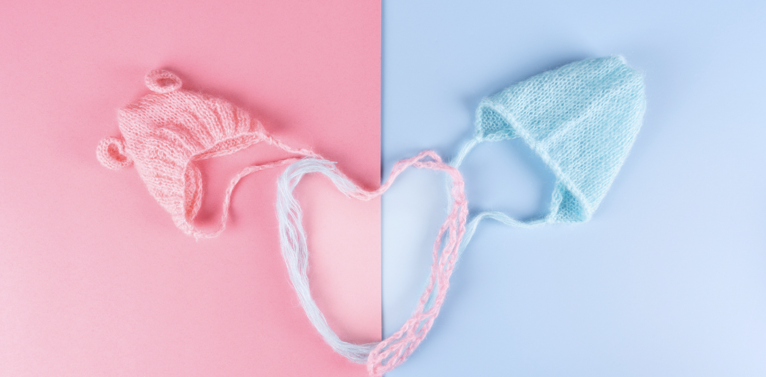 baby hats in a pink and blue background