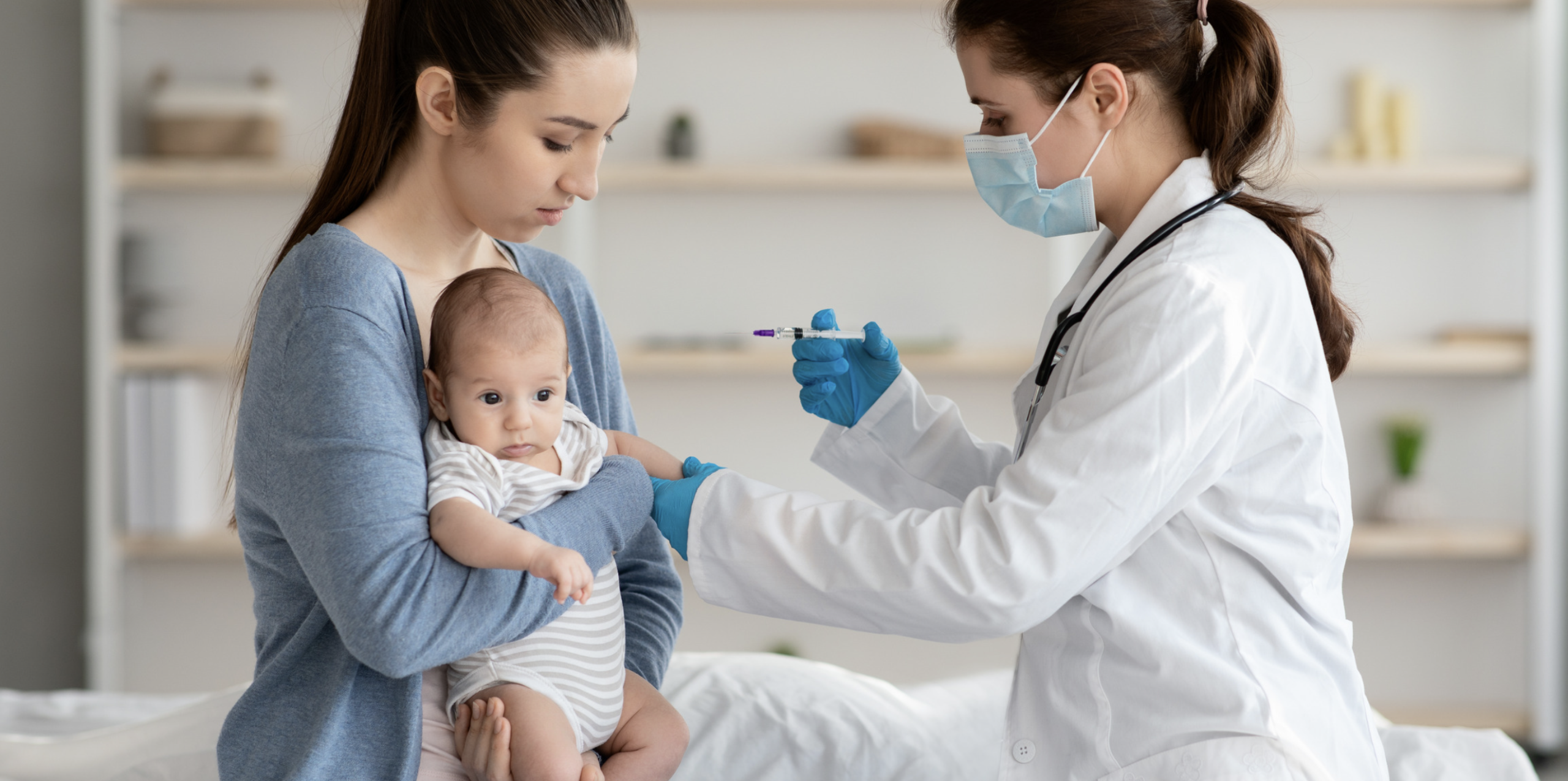 baby having an injection by doctor