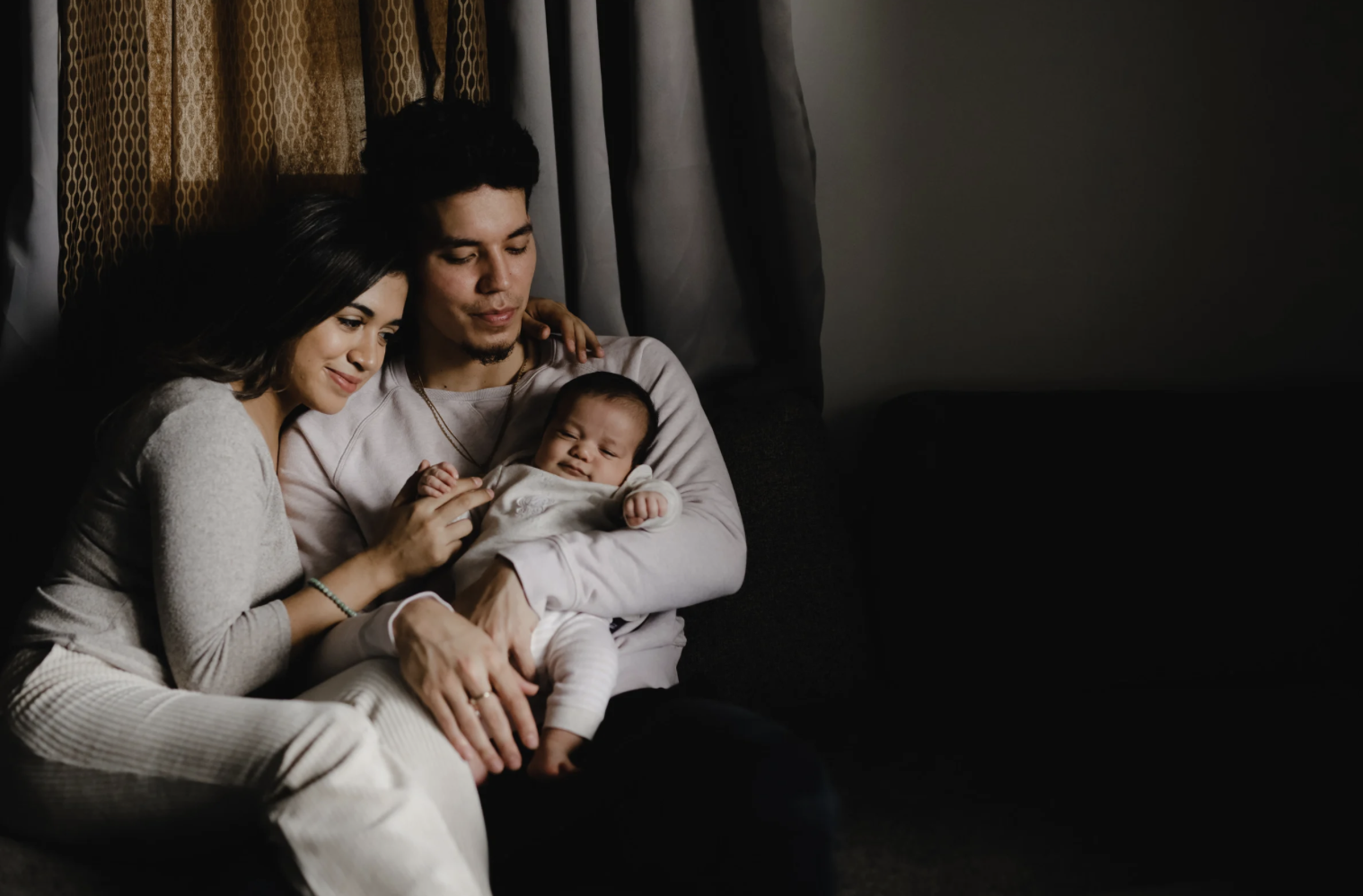 new parents holding baby