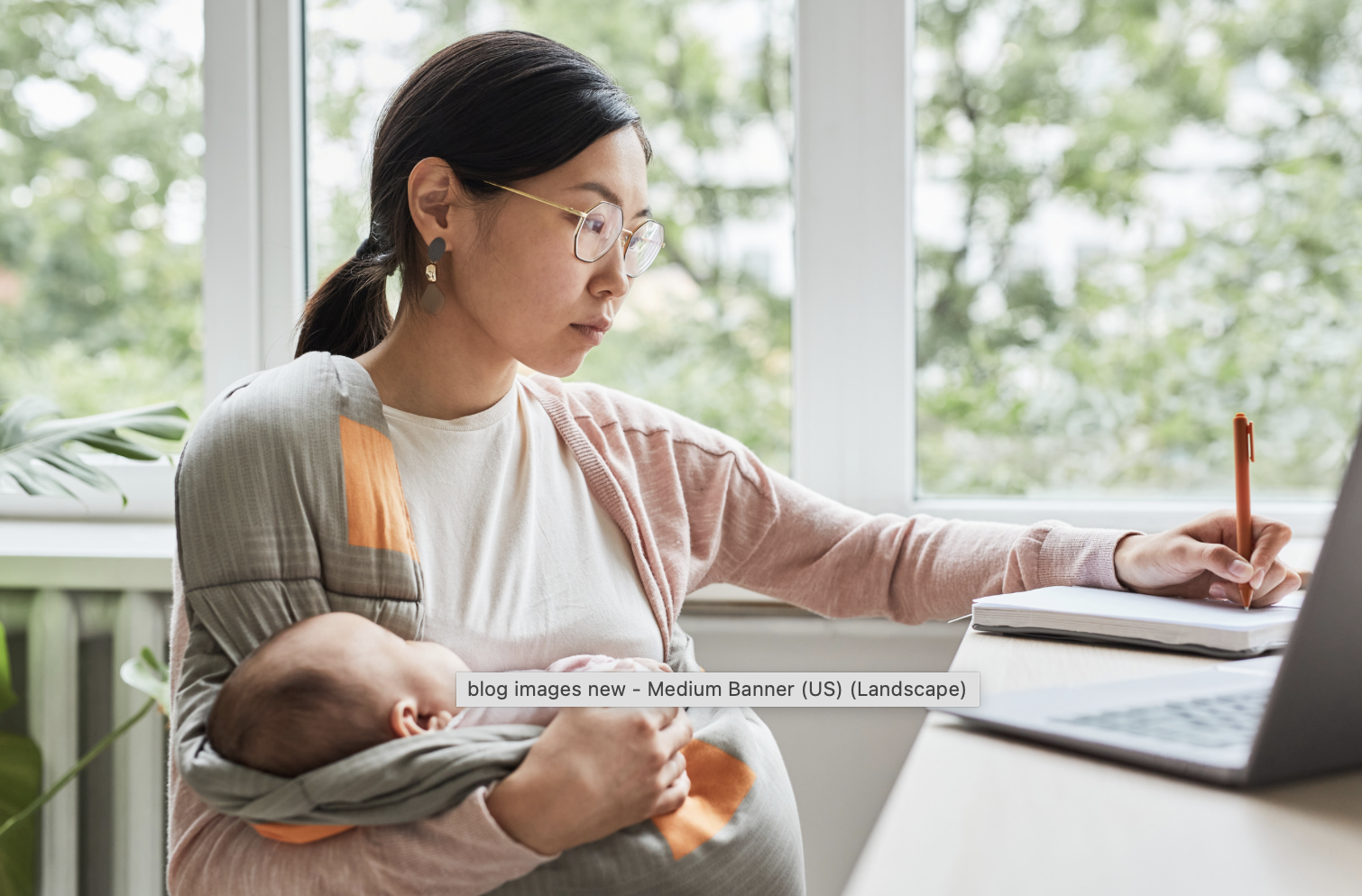 new mother working at her desk