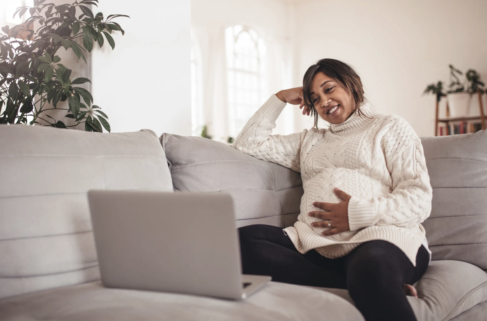 pregnant woman watching laptop