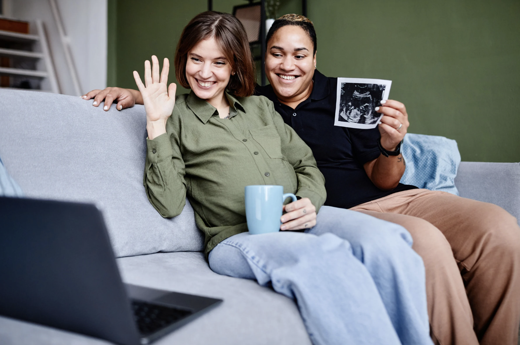 expecting couple on call on laptop