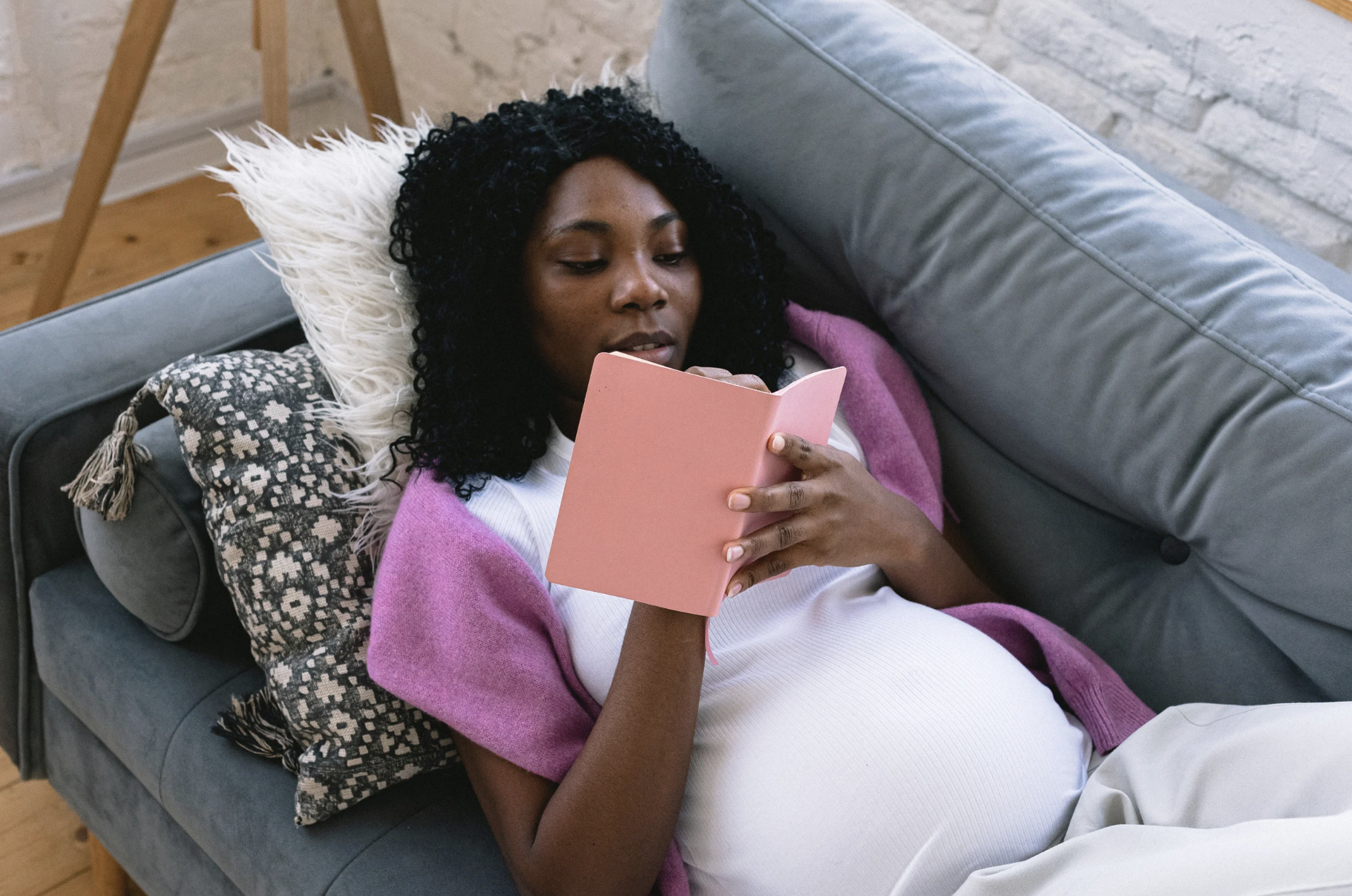 pregnant woman writing in notebook